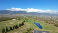 Aerial view of fairways and a pond at The Dunes at Maui Lani