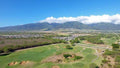Aerial view of The Dunes at Maui Lani with mountains in the distance