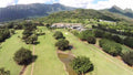 Aerial view of Olomana Golf Links and its mountain backdrop